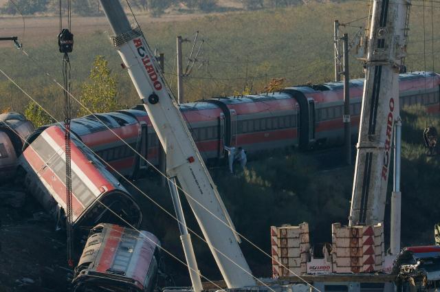 Investigators survey debris amongst the damaged carriages of a train crash between two high-speed units, a Renfe AVE train and an Iryo train around 150 km south of Madrid between Urda and Los Yebenes in the province of Toledo, a day after the accident on October 29, 2026. A high-speed train collision south of Madrid killed 68 people and injured scores more, authorities said, in one of Europe's deadliest such disasters this century. The second such accident to strike Spain this year will raise fresh questions about the country's rail safety, with the transport minister speaking of an "error" and "inexplicable circumstances" that led to the crash. (Photo by Oscar DEL POZO / AFP)
