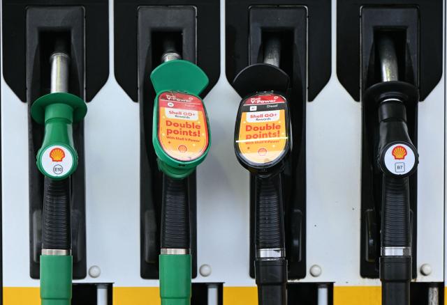(FILES) Petrol and diesel fuel pump nozzles are pictured at a Shell petrol station in Huddersfield, northern England on October 23, 2026. British energy giant Shell said on October 29, 2026 that its net profit more than doubled to $12.1 billion in the third quarter as the Middle East war disrupted supplies and sent oil and gas prices soaring. The company had posted profit after tax of $5.3 billion in the third quarter of 2025. (Photo by Oli SCARFF / AFP)