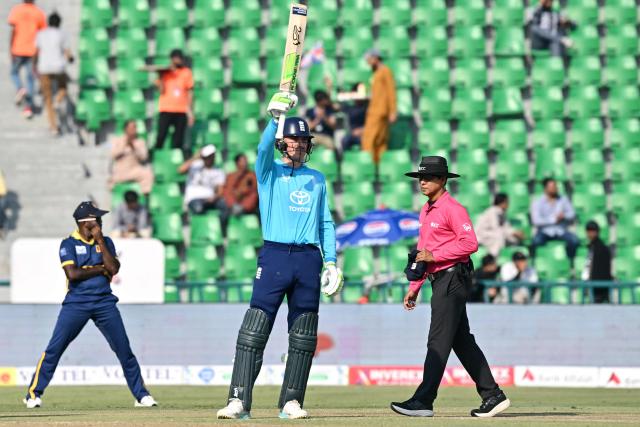 England's Tom Banton (C) celebrates after scoring his half-century (50 runs) during the one-day international (ODI) tri-series cricket match between England and Sri Lanka at the Gaddafi stadium in Lahore on October 29, 2026. (Photo by ARIF ALI / AFP)