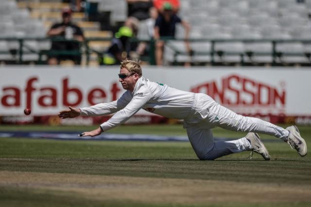South Africa's Simon Harmer attempts to field his own delivery on day three of the third Test match between South Africa and Australia at Newlands stadium in Cape Town on October 29, 2026. (Photo by Marco Longari / AFP)