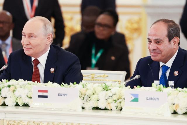 In this pool photograph distributed by the Russian state agency Sputnik, Russia's President Vladimir Putin and Egypt's President Abdel Fattah Al-Sisi attend a plenary session of the third Russia-Africa Summit in Moscow on October 29, 2026. (Photo by Alexander KAZAKOV / Pool / AFP)
