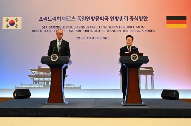 German Chancellor Friedrich Merz (L) and South Korean President Lee Jae Myung (R) attend a joint press announcement at the presidential Blue House in Seoul on October 29, 2026. (Photo by SONG Kyung-Seok / POOL / AFP)