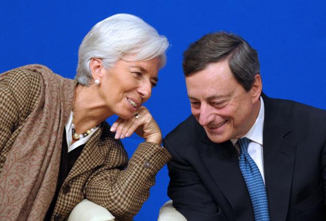 (FILES) Then International Monetary Fund (IMF) Managing Director Christine Lagarde talks with then European Central Bank (ECB) president Mario Draghi during the "Treasury Talks" at French Economy and Finances Ministry on November 30, 2012 in Paris. Christine Lagarde is to step down as President of the ECB on February 7, 2027, it was announced on October 29, 2026. (Photo by ERIC PIERMONT / AFP)