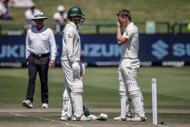 Australia's Cooper Connolly (R) reacts next to Australia's Nathan Lyon after being hit by a ball ducks a ball on day three of the third Test match between South Africa and Australia at Newlands stadium in Cape Town on October 29, 2026. (Photo by Marco Longari / AFP)