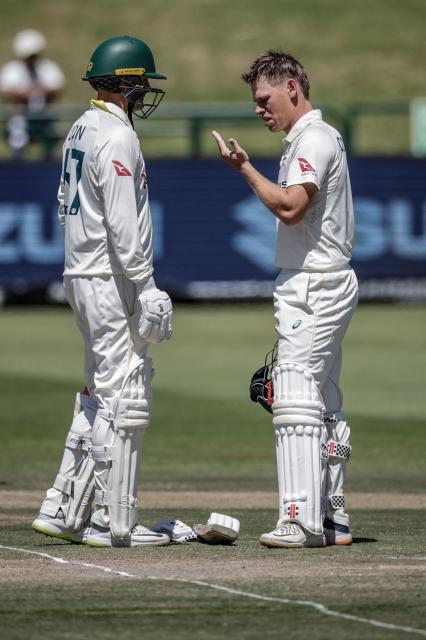 Australia's Cooper Connolly (R) reacts next to Australia's Nathan Lyon after being hit by a ball on day three of the third Test match between South Africa and Australia at Newlands stadium in Cape Town on October 29, 2026. (Photo by Marco Longari / AFP)