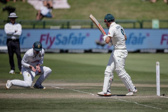 South Africa's Matthew Breetzke fields a ball played by Australia's Cooper Connolly (R) on day three of the third Test match between South Africa and Australia at Newlands stadium in Cape Town on October 29, 2026. (Photo by Marco Longari / AFP)