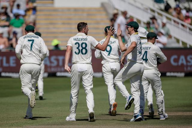 Australia's Josh Hazlewood (2nd L) celebrates with his teammates after dismissing South Africa's David Bedingham on day three of the third Test match between South Africa and Australia at Newlands stadium in Cape Town on October 29, 2026. (Photo by Marco Longari / AFP)