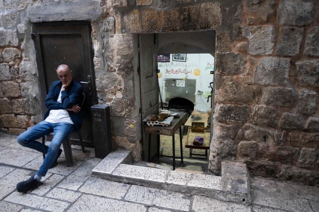A man waits for customers outside his bakery in the Old City of Jerusalem on October 29, 2026. (Photo by Jewel SAMAD / AFP)