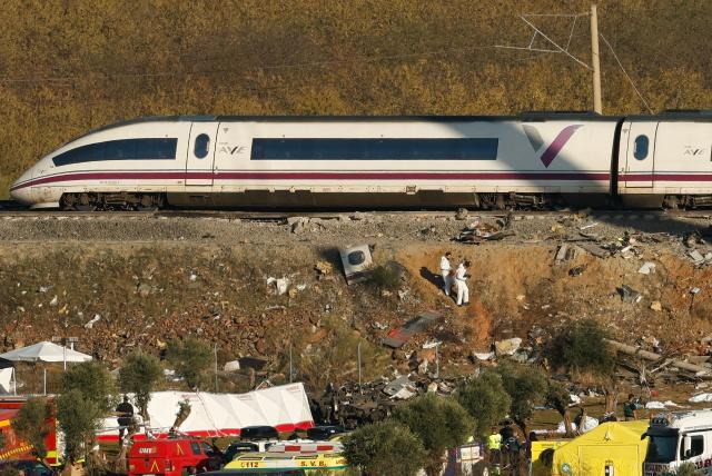Investigators work at the scene of a train crash between two high-speed units, a Renfe AVE train and an Iryo train in Urda, in the province of Toledo, one day after the deadly accident on October 29, 2026. A high-speed train collision south of Madrid killed 69 people and injured scores more, authorities said, in one of Europe's deadliest such disasters this century. The second such accident to strike Spain this year will raise fresh questions about the country's rail safety, with the transport minister speaking of an "error" and "inexplicable circumstances" that led to the crash. (Photo by Oscar DEL POZO / AFP)