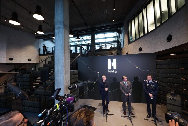 (L-R) Co-chief executive of Helsing Gundbert Scherf, Germany's defence minister Boris Pistorius, , and Spokesperson for the German Defence Ministry Florian Scholz address the media durinng a visit at defence technology start-up Helsing in Munich, southern Germany on October 29, 2026. (Photo by Karl-Josef Hildenbrand / AFP)