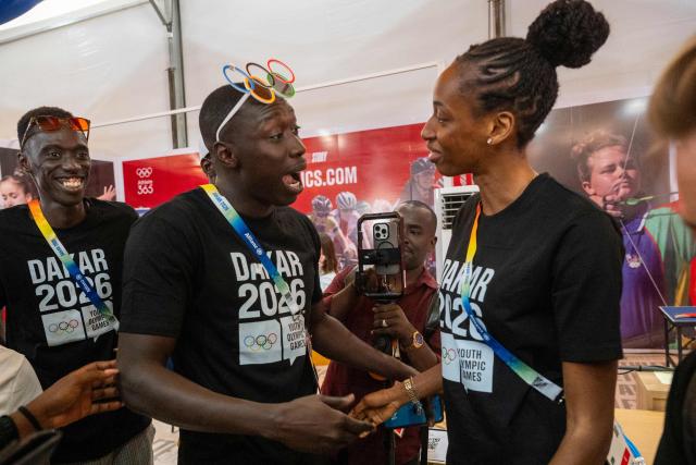 Senegal's Influencer and TikToker Khaby Lame (C) speaks with with Senegal's athlete Saly Sarr (R) during their visit to the Olympic Village ahead of the Dakar 2026 Youth Olympic Games in Diamniadio, on October 29, 2026. (Photo by SEYLLOU / AFP)