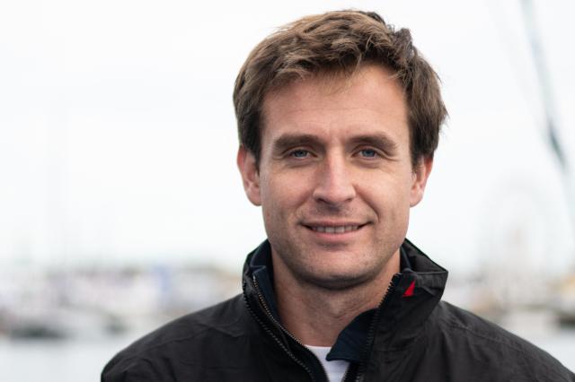 French skipper Tom Laperche poses for a photo session aboard his multihull Ultim class “SVR Lazartigue“ before the start of the 13th Route du Rhum Destination Guadeloupe on October 29, 2026. (Photo by Sebastien Salom-Gomis / AFP)