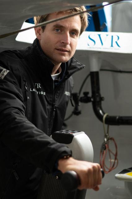 French skipper Tom Laperche poses for a photo session aboard his multihull Ultim class “SVR Lazartigue“ before the start of the 13th Route du Rhum Destination Guadeloupe on October 29, 2026. (Photo by Sebastien Salom-Gomis / AFP)