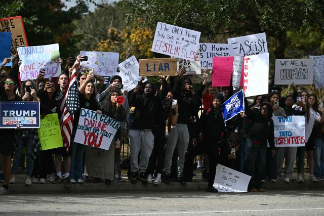 Protesters along the motorcade route where US President Donald Trump is due to speak at a midterm campaign rally at the Rock Hill Sports & Event Center in Rock Hill, South Carolina on October 29, 2026. (Photo by Kent NISHIMURA / AFP)