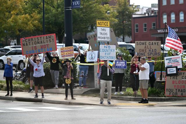 Protesters along the motorcade route as US President Donald Trump is due to speak at a midterm campaign rally at the Rock Hill Sports & Event Center in Rock Hill, South Carolina on October 29, 2026. (Photo by Kent NISHIMURA / AFP)