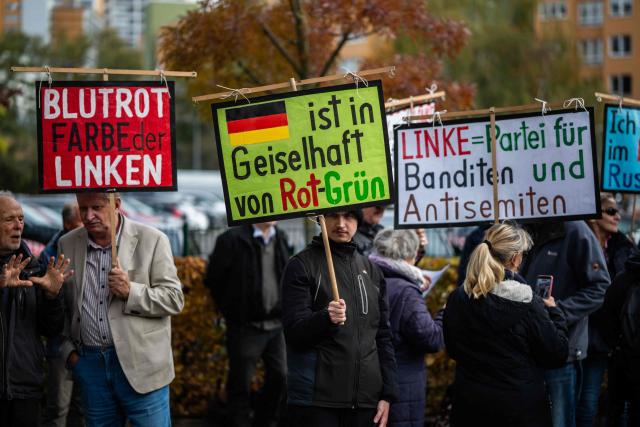 Demonstrators display placards outside the headquarters of the Social Democratic Party (SPD) in Berlin on October 29, 2026, criticising the SPD, the Left Party, as well as the Green party who are seeking to form a coalition government in Berlin. (Photo by John MACDOUGALL / AFP)
