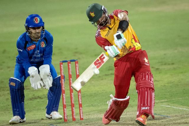 Zimbabwe's Sikandar Raza (R) plays a shot during the 2nd T20 cricket match between Afghanistan and Zimbabwe at the Sharjah Cricket Stadium in Sharjah on October 29, 2026. (Photo by FADEL SENNA / AFP)