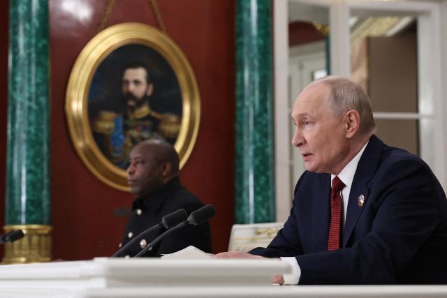 In this pool photograph distributed by the Russian state agency Sputnik, Russia's President Vladimir Putin (R) and Chairperson of the African Union and Burundi's President Evariste Ndayishimiye (L) address the media during the Russia-Africa summit at the Grand Kremlin Palace in Moscow on October 29, 2026. (Photo by Alexander KAZAKOV / POOL / AFP)