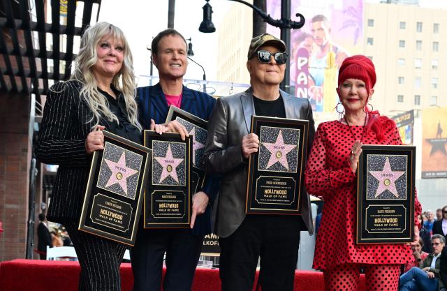 (From L) Members of the B-52s Cindy Wilson, Keith Strickland, Fred Schneider and Kate Pierson pose on their star during their Hollywood Walk of Fame ceremony in the Hollywood neighborhood of Los Angeles on October 29, 2026. (Photo by Frederic J. Brown / AFP) / ALTERNATE CROP