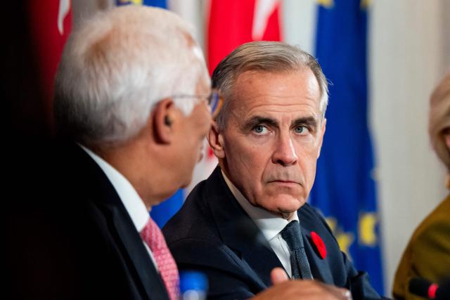 Canada's Prime Minister Mark Carney (R) listens as European Council President Antonio Costa (L) speaks during a roundtable with business leaders during the 21st EU-Canada summit in Montreal, Quebec, Canada on October 29, 2026. The EU and Canada want to bring their relationship to the "highest level possible" as they face a "world of growing rivalries," the 27-nation bloc's chief said Thursday ahead of a meeting with Canadian leader Mark Carney. Brussels and Ottawa are to lay the groundwork for an ever-closer partnership at a two-day summit in Montreal, as they navigate uncertain ties with the United States and China. (Photo by Christopher Katsarov / POOL / AFP)