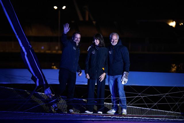 (From L) French skipper Louis Burton, French pilot and journalist Margot Lafitte, and French sailor Michel Desjoyeaux attend the inauguration of the Ultim multihull Armand Thiery, in the harbour of Saint-Malo northwestern France, on October 29, 2026 a few days prior to the start of the Route du Rhum solo sailing race from Saint-Malo, to Pointe-a-Pitre in the French overseas island of Guadeloupe. (Photo by Lou BENOIST / AFP)