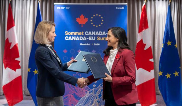 Canada's Minister of Foreign Affairs Anita Anand (R) and the Vice President of the European Commission Kaja Kallas exchange signed copies of the EU-Canada Host Country Agreement during the 21st EU-Canada summit in Montreal, Quebec, Canada on October 29, 2026. The EU and Canada want to bring their relationship to the "highest level possible" as they face a "world of growing rivalries," the 27-nation bloc's chief said Thursday ahead of a meeting with Canadian leader Mark Carney. Brussels and Ottawa are to lay the groundwork for an ever-closer partnership at a two-day summit in Montreal, as they navigate uncertain ties with the United States and China. (Photo by Christinne Muschi / POOL / AFP)