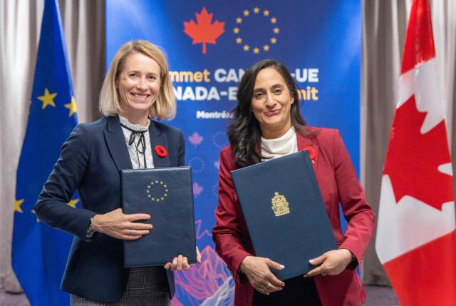 Canada's Minister of Foreign Affairs Anita Anand (R) and the Vice President of the European Commission Kaja Kallas pose with signed copies of the EU-Canada Host Country Agreement during the 21st EU-Canada summit in Montreal, Quebec, Canada on October 29, 2026. The EU and Canada want to bring their relationship to the "highest level possible" as they face a "world of growing rivalries," the 27-nation bloc's chief said Thursday ahead of a meeting with Canadian leader Mark Carney. Brussels and Ottawa are to lay the groundwork for an ever-closer partnership at a two-day summit in Montreal, as they navigate uncertain ties with the United States and China. (Photo by Christinne Muschi / POOL / AFP)