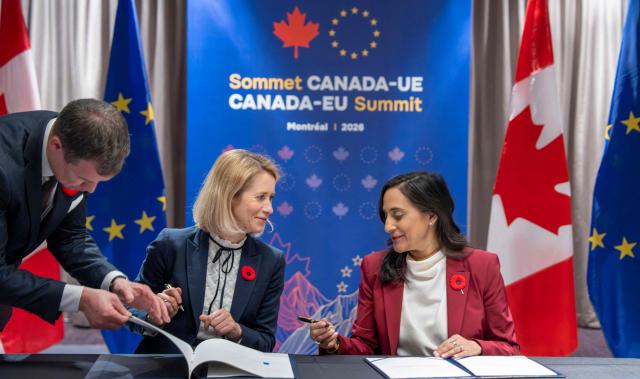 Canada's Minister of Foreign Affairs Anita Anand (R) and the Vice President of the European Commission Kaja Kallas sign the EU-Canada Host Country Agreement during the 21st EU-Canada summit in Montreal, Quebec, Canada on October 29, 2026. The EU and Canada want to bring their relationship to the "highest level possible" as they face a "world of growing rivalries," the 27-nation bloc's chief said Thursday ahead of a meeting with Canadian leader Mark Carney. Brussels and Ottawa are to lay the groundwork for an ever-closer partnership at a two-day summit in Montreal, as they navigate uncertain ties with the United States and China. (Photo by Christinne Muschi / POOL / AFP)