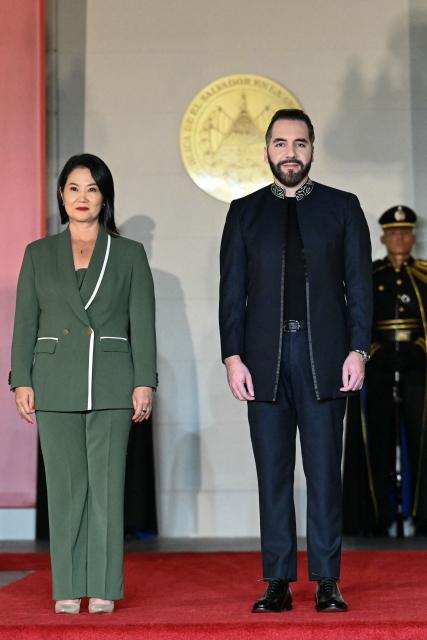 El Salvador's President Nayib Bukele (R) welcomes Peru's President Keiko Fujimori during an official reception at the Presidential House in San Salvador on October 29, 2026. (Photo by Marvin RECINOS / AFP)