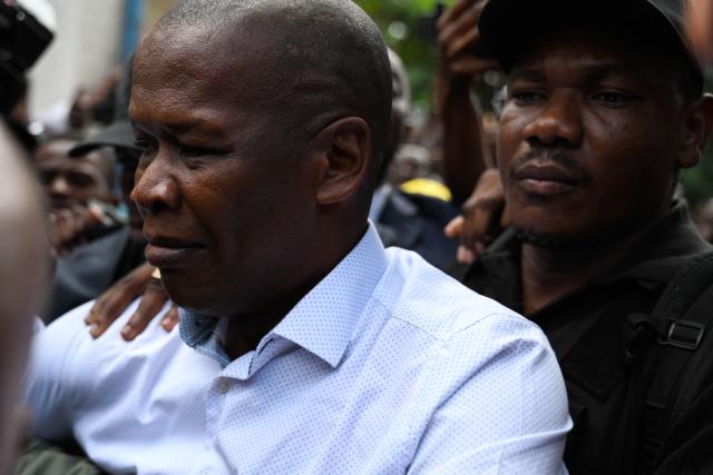 Haitian public prosecutor and Government Commissioner Jean Ernest Muscadin (L) is surrounded by security and supporters upon his arrival to an electoral office to register as a presidential candidate in Port-au-Prince, Haiti, on October 29, 2026. Haiti will hold the first round of presidential and legislative elections on July 18, 2027, the country's Provisional Electoral Council said on October 28, in what would mark the first polls in the crisis-stricken country in more than a decade. Elections are seen as a crucial step to stabilizing the government and tackling rampant crime in Haiti, which has been engulfed for years by gang warfare and political chaos. (Photo by Clarens SIFFROY / AFP)