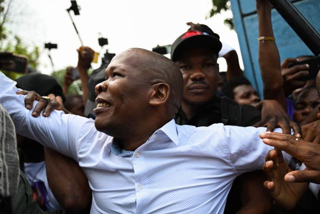 Haitian public prosecutor and Government Commissioner Jean Ernest Muscadin is surrounded by security and supporters upon his arrival to an electoral office to register as a presidential candidate in Port-au-Prince, Haiti, on October 29, 2026. Haiti will hold the first round of presidential and legislative elections on July 18, 2027, the country's Provisional Electoral Council said on October 28, in what would mark the first polls in the crisis-stricken country in more than a decade. Elections are seen as a crucial step to stabilizing the government and tackling rampant crime in Haiti, which has been engulfed for years by gang warfare and political chaos. (Photo by Clarens SIFFROY / AFP)