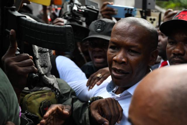 Haitian public prosecutor and Government Commissioner Jean Ernest Muscadin is surrounded by security and supporters upon his arrival to an electoral office to register as a presidential candidate in Port-au-Prince, Haiti, on October 29, 2026. Haiti will hold the first round of presidential and legislative elections on July 18, 2027, the country's Provisional Electoral Council said on October 28, in what would mark the first polls in the crisis-stricken country in more than a decade. Elections are seen as a crucial step to stabilizing the government and tackling rampant crime in Haiti, which has been engulfed for years by gang warfare and political chaos. (Photo by Clarens SIFFROY / AFP)