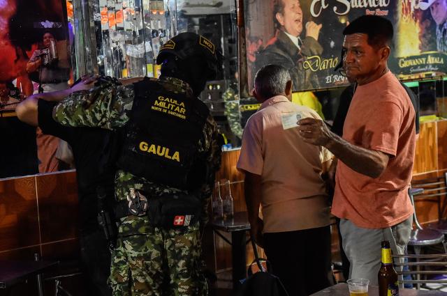 Colombian soldiers conduct searches in a bar in Cucuta, Norte de Santander, Colombia, on October 29, 2026. Colombian President Abelardo de la Espriella on October 29, ordered the temporary "militarization" of a city bordering Venezuela after a wave of recent violence linked to criminal groups. Over the past few days in Cucuta, the capital of the Norte de Santander department, a mayoral candidate was murdered and a bombing left four police officers injured, according to the local government. (Photo by Schneyder Mendoza / AFP)