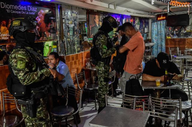 Colombian soldiers conduct searches in a bar in Cucuta, Norte de Santander, Colombia, on October 29, 2026. Colombian President Abelardo de la Espriella on October 29, ordered the temporary "militarization" of a city bordering Venezuela after a wave of recent violence linked to criminal groups. Over the past few days in Cucuta, the capital of the Norte de Santander department, a mayoral candidate was murdered and a bombing left four police officers injured, according to the local government. (Photo by Schneyder Mendoza / AFP)