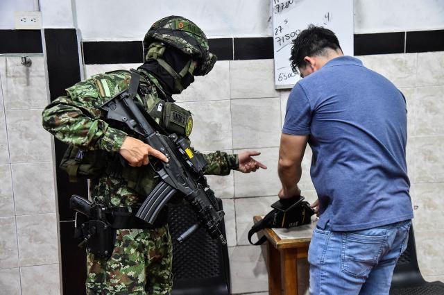 A Colombian soldier conducts searches in a bar in Cucuta, Norte de Santander, Colombia, on October 29, 2026. Colombian President Abelardo de la Espriella on October 29, ordered the temporary "militarization" of a city bordering Venezuela after a wave of recent violence linked to criminal groups. Over the past few days in Cucuta, the capital of the Norte de Santander department, a mayoral candidate was murdered and a bombing left four police officers injured, according to the local government. (Photo by Schneyder Mendoza / AFP)