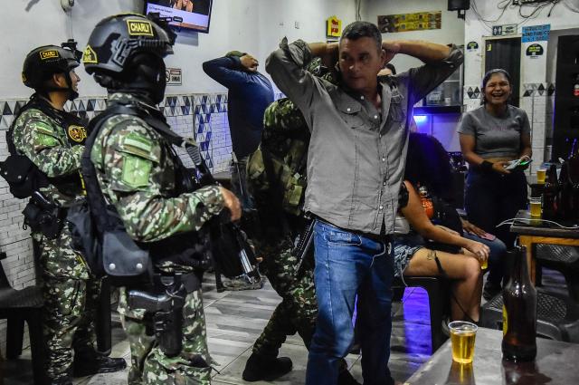 Colombian soldiers conduct searches in a bar in Cucuta, Norte de Santander, Colombia, on October 29, 2026. Colombian President Abelardo de la Espriella on October 29, ordered the temporary "militarization" of a city bordering Venezuela after a wave of recent violence linked to criminal groups. Over the past few days in Cucuta, the capital of the Norte de Santander department, a mayoral candidate was murdered and a bombing left four police officers injured, according to the local government. (Photo by Schneyder Mendoza / AFP)