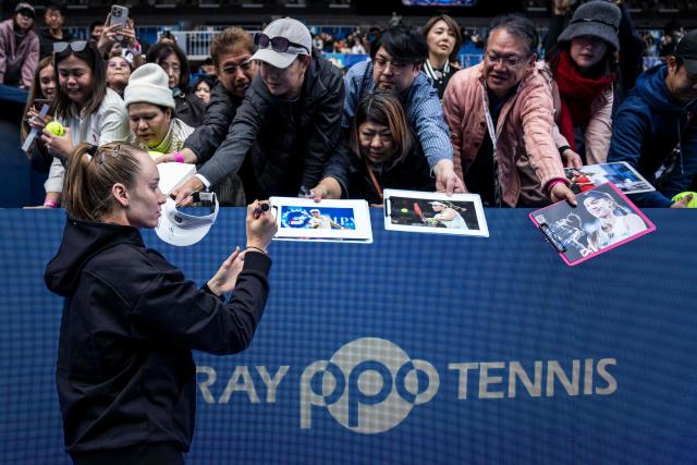 Kazakhstan's Elena Rybakina signs autographs after retiring due to an injury from her quarter-final match against Canada's Leylah Fernandez during the WTA Pan Pacific Open tennis tournament at Ariake Coliseum in Tokyo on October 30, 2026. Elena Rybakina withdrew with a neck injury, a day after she secured the year-end world number one ranking. (Photo by Yuichi YAMAZAKI / AFP)