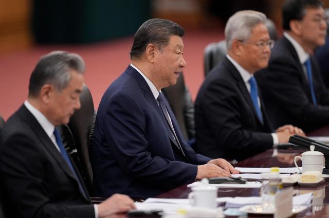 Chinese President Xi Jinping (C) attends a meeting with Switzerland's President Guy Parmelin at the Great Hall of the People in Beijing on October 30, 2026. (Photo by Kai Naito / POOL / AFP)