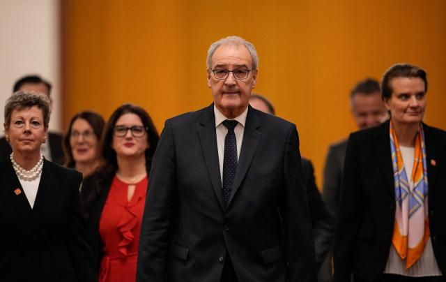 Switzerland's President Guy Parmelin (C) heads to a meeting with Chinese President Xi Jinping at the Great Hall of the People in Beijing on October 30, 2026. (Photo by Kai Naito / POOL / AFP)