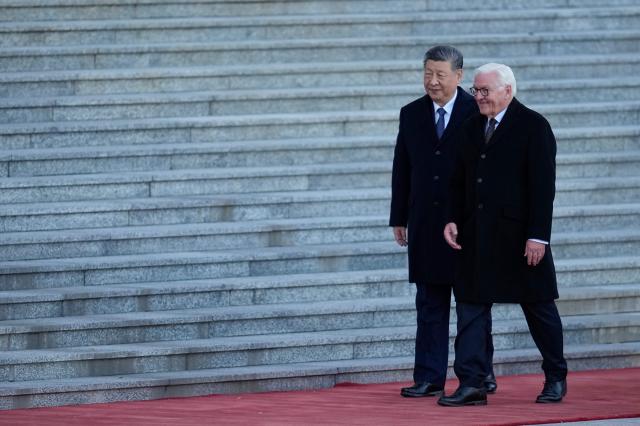 Chinese President Xi Jinping (L) and Germany’s President Frank-Walter Steinmeier attend a welcoming ceremony outside the Great Hall of the People in Beijing on October 30, 2026. (Photo by Kai Naito / POOL / AFP)