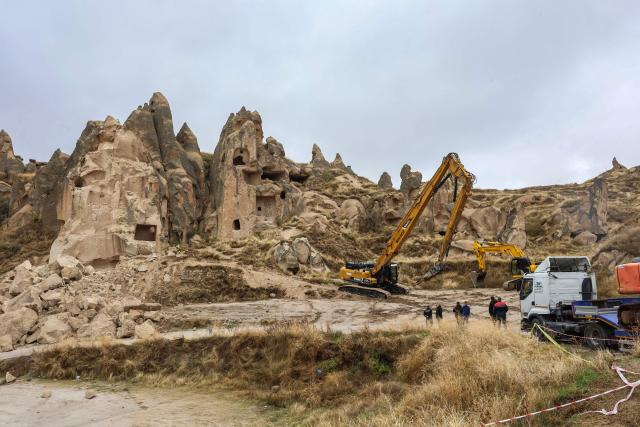 Officials inspect the site of a rock formation that collapsed due to a landslide triggered by heavy rains in Cappadocia district of Nevsehir, on October 30, 2026. A landslide triggered by heavy rainfall caused a rock spire to collapse in Turkey's UNESCO World Heritage-listed Cappadocia region on Thursday, killing at least two people, officials said. (Photo by Adem ALTAN / AFP)