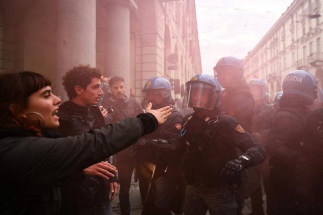 Students faces Italian police officers during a demonstration part of a nationwide day of strikes and protests as school and university students demand more funding for schools and support for housing, inTurin on October 30, 2026. Students have been protesting for weeks, setting up tent camps and occupying schools to make their demands heard, matching similar movements across the border in France. The Italian protests have taken place alongside those of truck drivers and farmers over the spike in fuel prices and the cost of living, as well as rising defence spending. (Photo by Marco BERTORELLO / AFP)