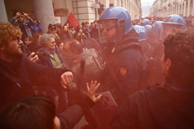 Students faces Italian police officers during a demonstration part of a nationwide day of strikes and protests as school and university students demand more funding for schools and support for housing, inTurin on October 30, 2026. Students have been protesting for weeks, setting up tent camps and occupying schools to make their demands heard, matching similar movements across the border in France. The Italian protests have taken place alongside those of truck drivers and farmers over the spike in fuel prices and the cost of living, as well as rising defence spending. (Photo by Marco BERTORELLO / AFP)