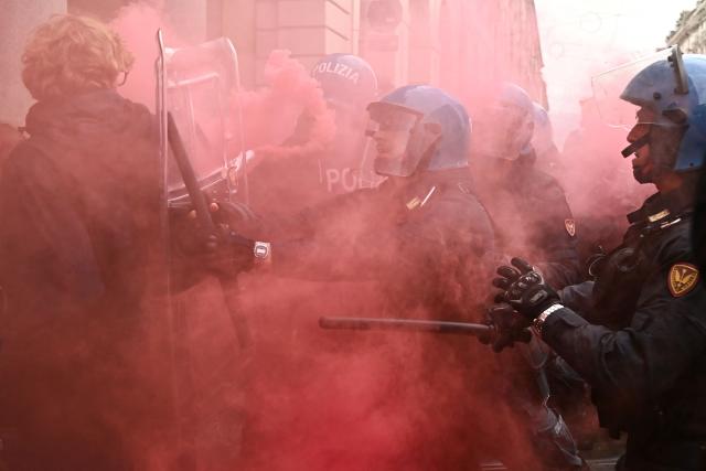 Students faces Italian police officers during a demonstration part of a nationwide day of strikes and protests as school and university students demand more funding for schools and support for housing, inTurin on October 30, 2026. Students have been protesting for weeks, setting up tent camps and occupying schools to make their demands heard, matching similar movements across the border in France. The Italian protests have taken place alongside those of truck drivers and farmers over the spike in fuel prices and the cost of living, as well as rising defence spending. (Photo by Marco BERTORELLO / AFP)