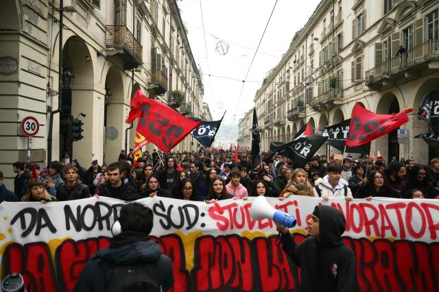 Students march begind a banner during a demonstration part of a nationwide day of strikes and protests as school and university students demand more funding for schools and support for housing, inTurin on October 30, 2026. Students have been protesting for weeks, setting up tent camps and occupying schools to make their demands heard, matching similar movements across the border in France. The Italian protests have taken place alongside those of truck drivers and farmers over the spike in fuel prices and the cost of living, as well as rising defence spending. (Photo by Marco BERTORELLO / AFP)