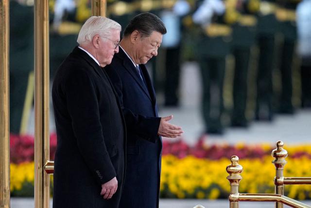 Chinese President Xi Jinping (R) and Germany’s President Frank-Walter Steinmeier attend a welcoming ceremony outside the Great Hall of the People in Beijing on October 30, 2026. (Photo by Kai Naito / POOL / AFP)
