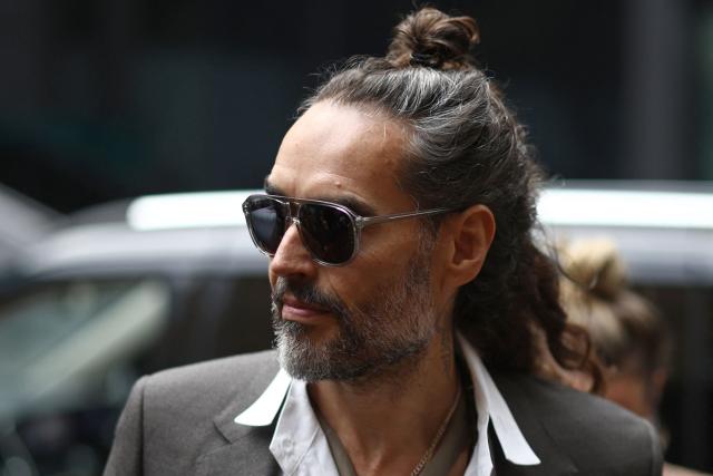 British comedian and actor Russell Brand arrives at the Southwark Crown Court as his rape and sexual assault trial continues in south London on October 30, 2026. The wife of British comedian and actor Russell Brand testified Thursday at his trial for rape and sexual assault, saying he had found monogamy "difficult" but became an "amazing" husband. (Photo by Henry NICHOLLS / AFP)