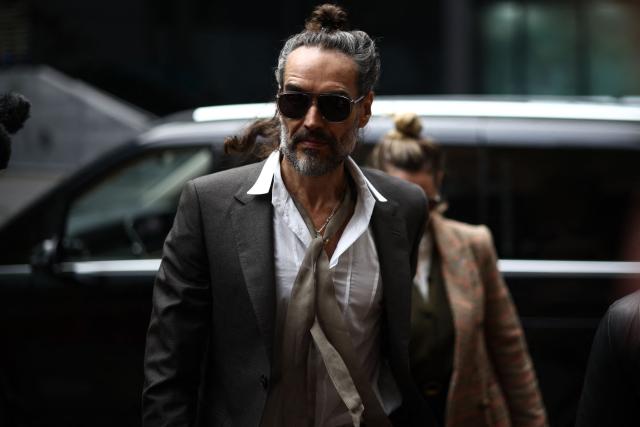 British comedian and actor Russell Brand arrives at the Southwark Crown Court as his rape and sexual assault trial continues in south London on October 30, 2026. The wife of British comedian and actor Russell Brand testified Thursday at his trial for rape and sexual assault, saying he had found monogamy "difficult" but became an "amazing" husband. (Photo by Henry NICHOLLS / AFP)