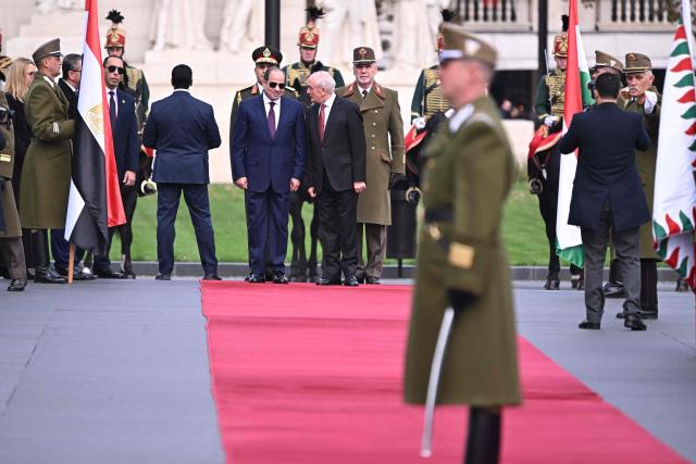 Egyptian President Abdel Fattah al-Sisi (C-L) and Hungary's President Andras Baka (C-R) inspect a military honour guard at Kossuth square in Budapest, Hungary, on October 30, 2026, during an official welcome ceremony. (Photo by Attila KISBENEDEK / AFP)