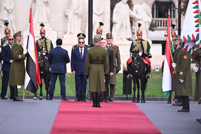 Egyptian President Abdel Fattah al-Sisi (C-L) and Hungary's President Andras Baka (C-R) inspect a military honour guard at Kossuth square in Budapest, Hungary, on October 30, 2026, during an official welcome ceremony. (Photo by Attila KISBENEDEK / AFP)